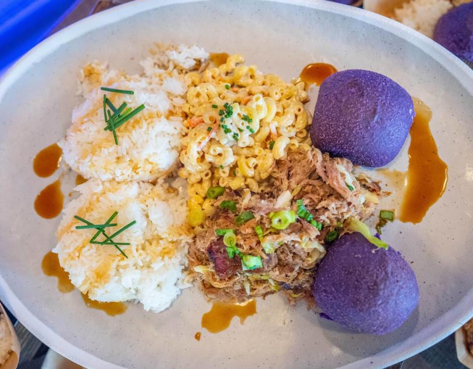 The kalua pork plate from Smokehouse BBQ is presented at the media food tasting event at the Golden 1 Center on Monday. It features shredded pork, macaroni salad, jasmine rice and purple ube rolls.