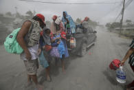 In this Monday, Jan. 13, 2020, photo,A family evacuates to safer grounds as Taal volcano in Tagaytay, Cavite province, southern Philippines. (AP Photo/Aaron Favila)