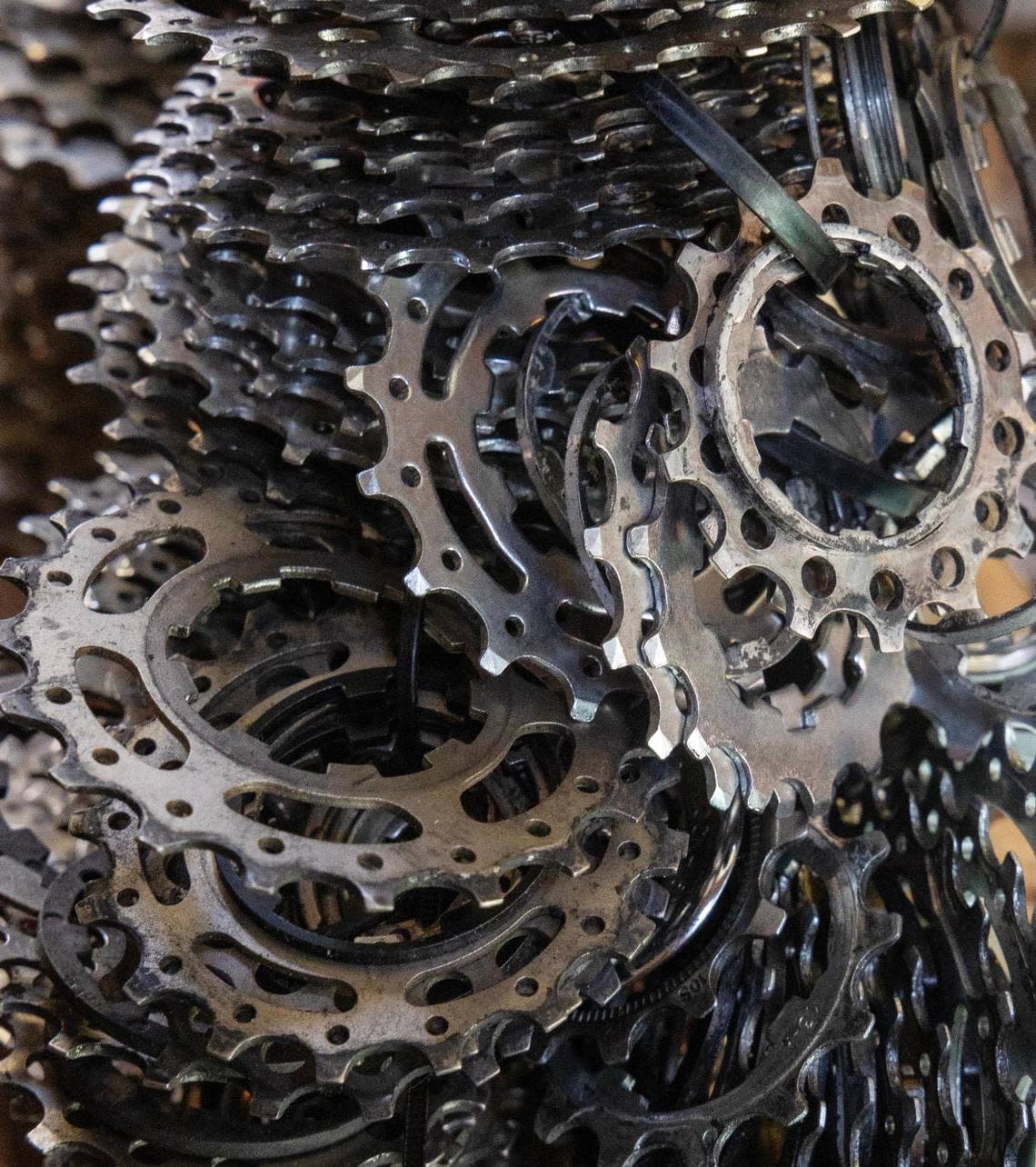Gears are stacked in a room filled with parts for fixing bicycles at the Boise Bicycle Project.