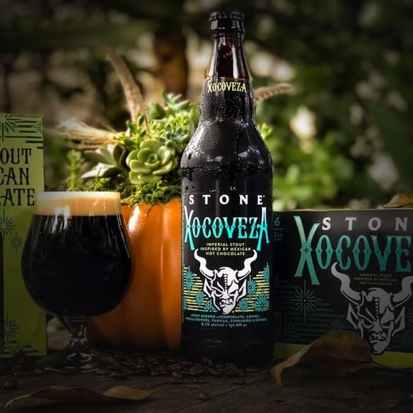 A bottle of Stone Brewing Xocoveza with the Stone gargoyle logo displayed.