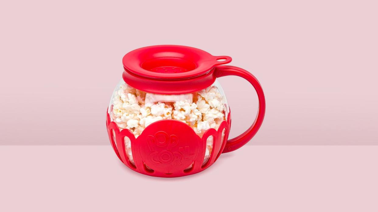 a red mug with popcorn in it