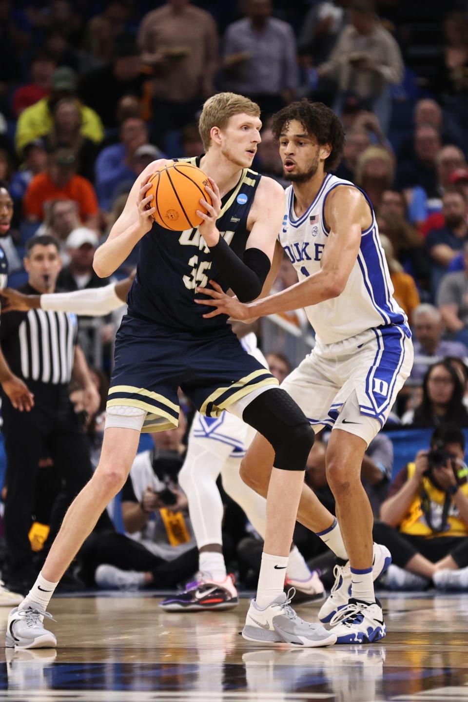 Mar 16, 2023; Orlando, FL, USA; Oral Roberts Golden Eagles forward Connor Vanover (35) controls the ball while defended by Duke Blue Devils center Dereck Lively II (1) during the first half at Amway Center. Mandatory Credit: Matt Pendleton-USA TODAY Sports