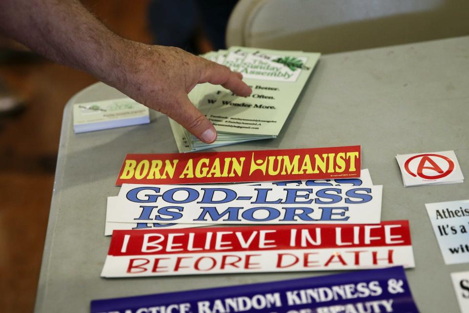 An attendee grabs a brochure at the Sunday Assembly in Los Angeles in 2013. <a href="https://newsroom.ap.org/detail/AtheistMegachurches/b0e301a630c643f2aae47f2cabea555f/photo?Query=%22sunday%20assembly%22&mediaType=photo&sortBy=arrivaldatetime:desc&dateRange=Anytime&totalCount=9&currentItemNo=8" rel="nofollow noopener" target="_blank" data-ylk="slk:AP Photo/Jae C. Hong;elm:context_link;itc:0;sec:content-canvas" class="link ">AP Photo/Jae C. Hong</a>