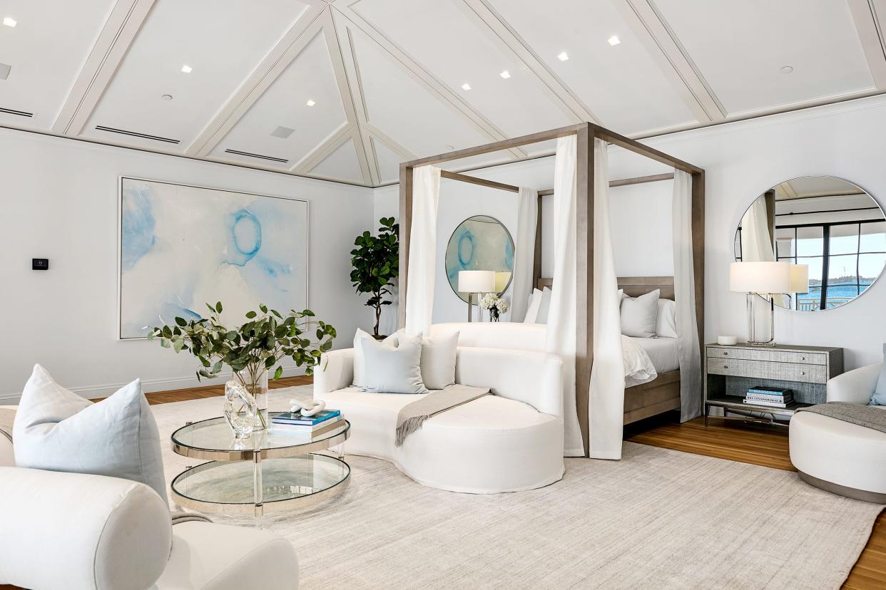 A pitched-and-beamed ceiling crowns the main bedroom at 10 Tarpon Island in Palm Beach.