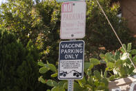 A "Vaccine Parking Only" sign is posted near the driveway of a private home in Los Angeles, Monday, Nov. 29, 2021. Enforcement began Monday in Los Angeles for one of the strictest vaccine mandates in the country, a sweeping measure that requires proof of COVID-19 shots for everyone entering a wide variety of businesses from restaurants to theaters and gyms to nail and hair salons. (AP Photo/Damian Dovarganes)