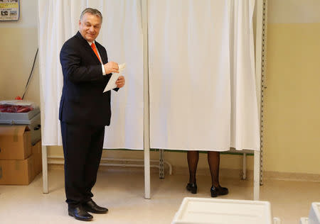 Current Hungarian Prime Minister Viktor Orban leaves a polling booth to cast his ballot during Hungarian parliamentary election in Budapest, Hungary, April 8, 2018. REUTERS/Bernadett Szabo