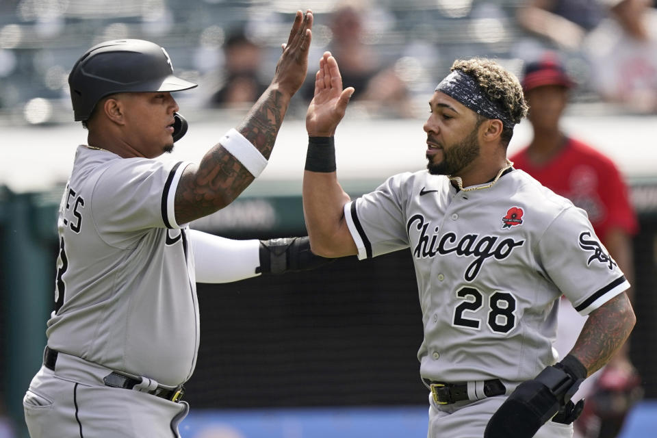 Chicago White Sox's Leury Garcia, right, and Yermin Mercedes celebrate after both score in the second inning of the first baseball game of a doubleheader against the Cleveland Indians, Monday, May 31, 2021, in Cleveland. (AP Photo/Tony Dejak)