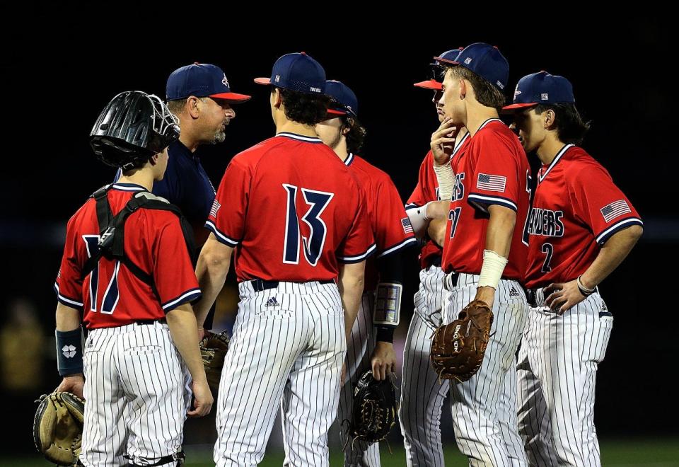 Governor Livingston players meet on the mound against Cranford in the Union County Tournament baseball final on May 15, 2023