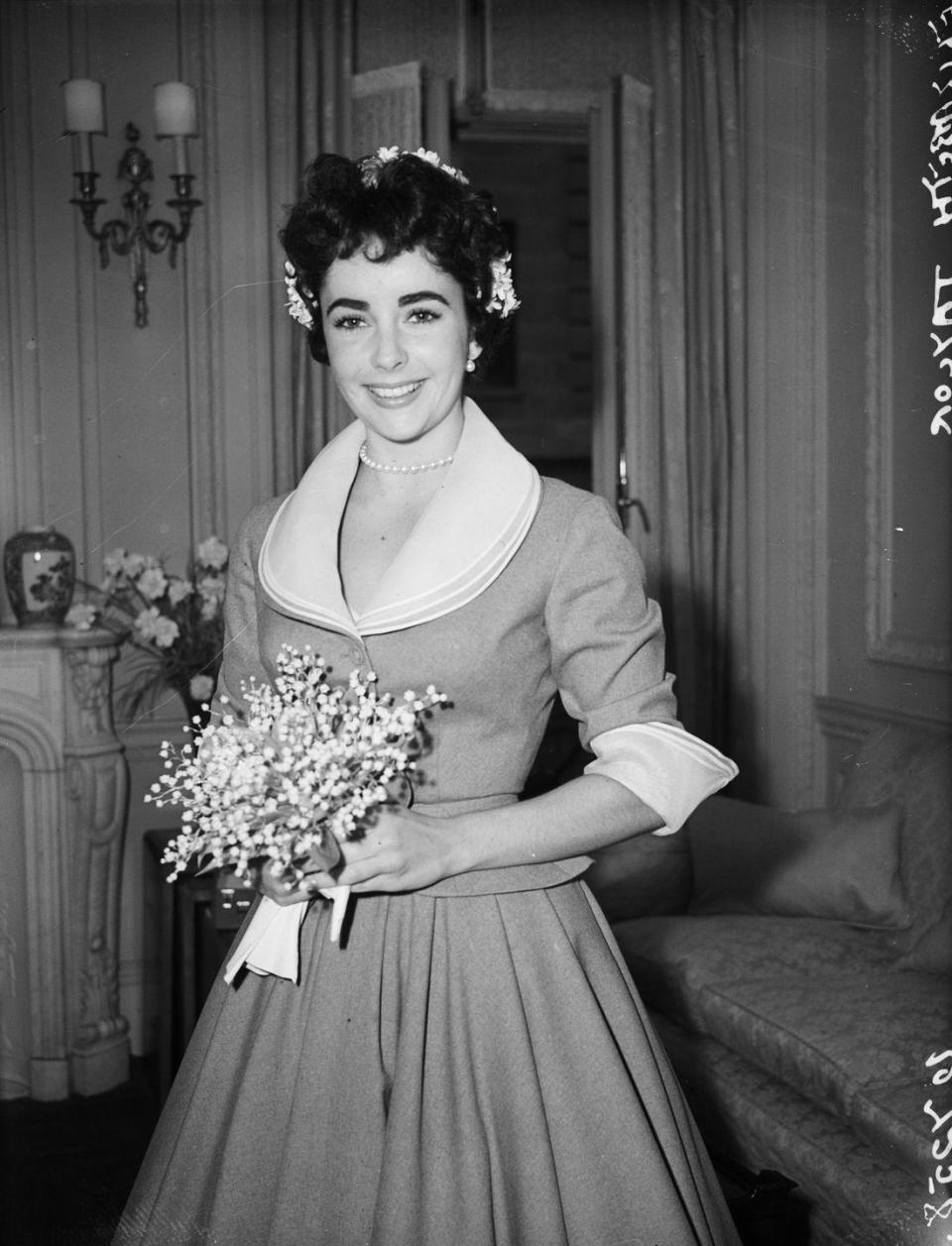 <p>While she wore several gowns for her many marriages, Elizabeth Taylor's first unconventional dress was this simple suit for her 1952 wedding to her second husband, Michael Wilding.</p>