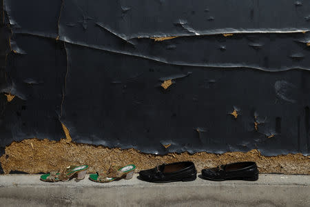 Shoes are displayed outside a hut as its inhabitants prepare to move out of the Roma shanty town of El Gallinero, on the outskirts of Madrid, Spain, September 25, 2018. REUTERS/Susana Vera