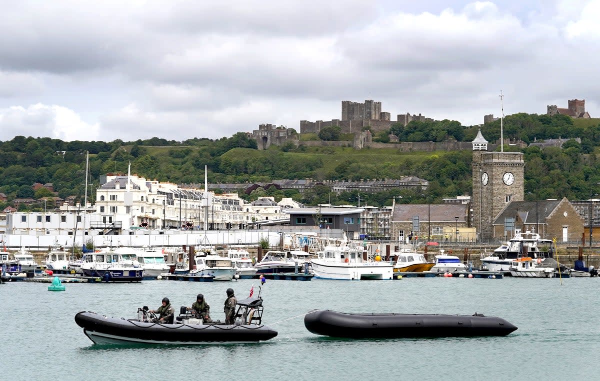 Military personnel tow a dinghy thought to be used by migrants in to Dover, Kent (Gareth Fuller/PA) (PA Wire)