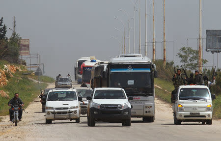 A convoy of buses carrying Sunni rebels and civilians, who were evacuated from Zabadani and Madaya, as part of a reciprocal evacuation deal for four besieged towns, travels towards rebel-held Idlib, Syria April 21, 2017. REUTERS/Ammar Abdullah