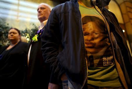 Peter Blenkiron, a child sex abuse victim, wears a t-shirt that says "no more silence" as he stands in front of the Quirinale hotel in Rome, Italy, February 28, 2016. REUTERS/Alessandro Bianchi