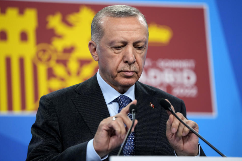 Turkish President Recep Tayyip Erdogan tests the microphone prior to addressing a media conference at a NATO summit in Madrid, Spain on Thursday, June 30, 2022. North Atlantic Treaty Organization heads of state met for the final day of a NATO summit in Madrid on Thursday. (AP Photo/Manu Fernandez)