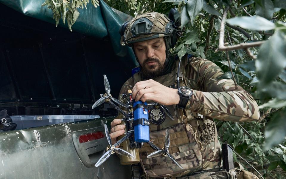 A Ukrainian soldier prepares a drone on the front line in Zaporizhzhia