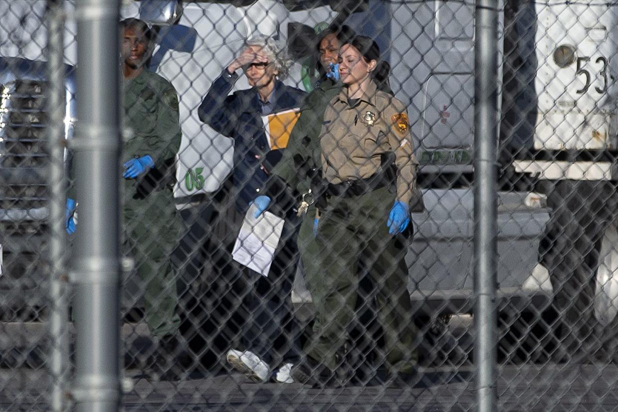 In this file photo, Margaret Rudin, second from left, is escorted out of Florence McClure Women's Correctional Center by prison staff on Jan. 10, 2020, in North Las Vegas.