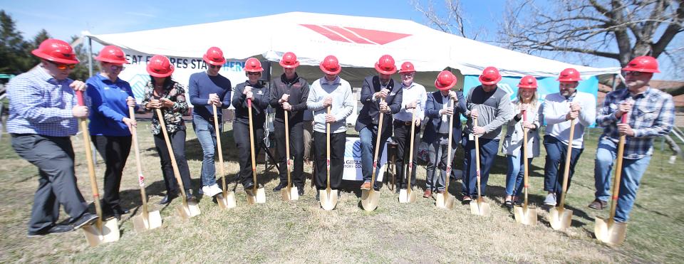 Board members and supporters of the Ames Boys & Girls Clubs break ground during the ceremony at South 5th Street on Friday, April 5, 2024, in Ames, Iowa.