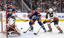 Anaheim Ducks goalie John Gibson (36) makes a save on Edmonton Oilers' Zach Hyman (18) as Simon Benoit (13) defends during the second period of an NHL hockey game Saturday, April 1, 2023, in Edmonton, Alberta. (Jason Franson/The Canadian Press via AP)