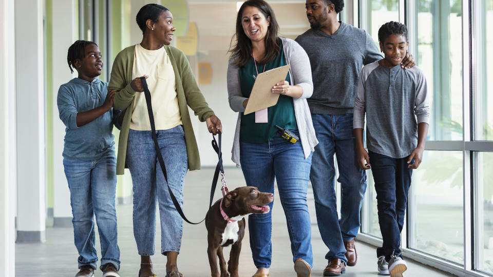 Family adopting pet dog from animal shelter