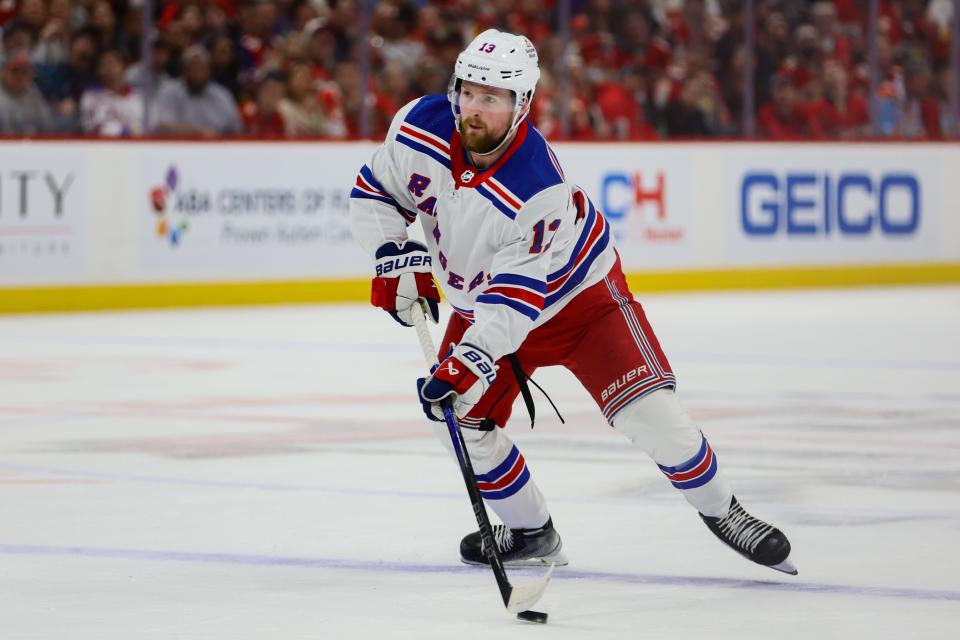 May 28, 2024; Sunrise, Florida, USA; New York Rangers left wing Alexis Lafreniere (13) moves the puck against the Florida Panthers during the first period in game four of the Eastern Conference Final of the 2024 Stanley Cup Playoffs at Amerant Bank Arena. Mandatory Credit: Sam Navarro-USA TODAY Sports