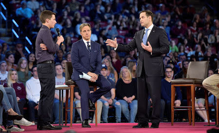 Marjory Stoneman Douglas student Cameron Kasky (L) asks Senator Marco Rubio if he will continue to accept money from the NRA during a CNN town hall meeting, at the BB&T Center, in Sunrise, Florida, U.S. February 21, 2018. REUTERS/Michael Laughlin/Pool