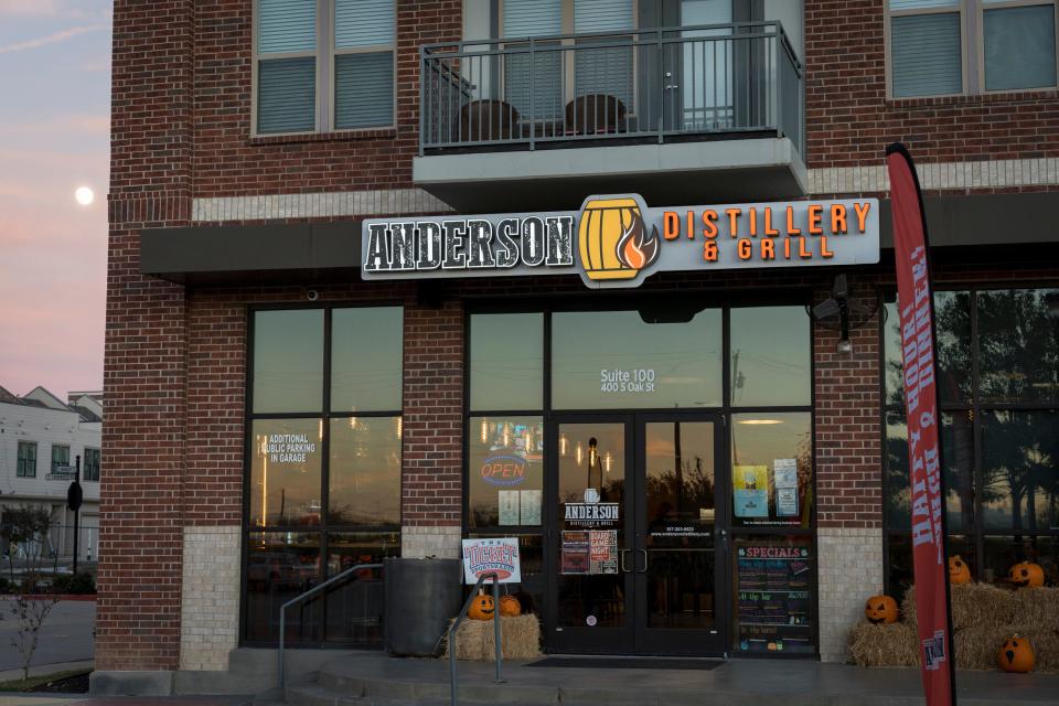 A nearly full moon rises behind the Anderson Distillery & Grill on South Oak Street in downtown Roanoke, Texas.