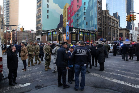 New York Police Department (NYPD) officers stand guard near Port Authority Bus Terminal after reports of an explosion in Manhattan, New York, U.S., December 11, 2017. REUTERS/Amr Alfiky