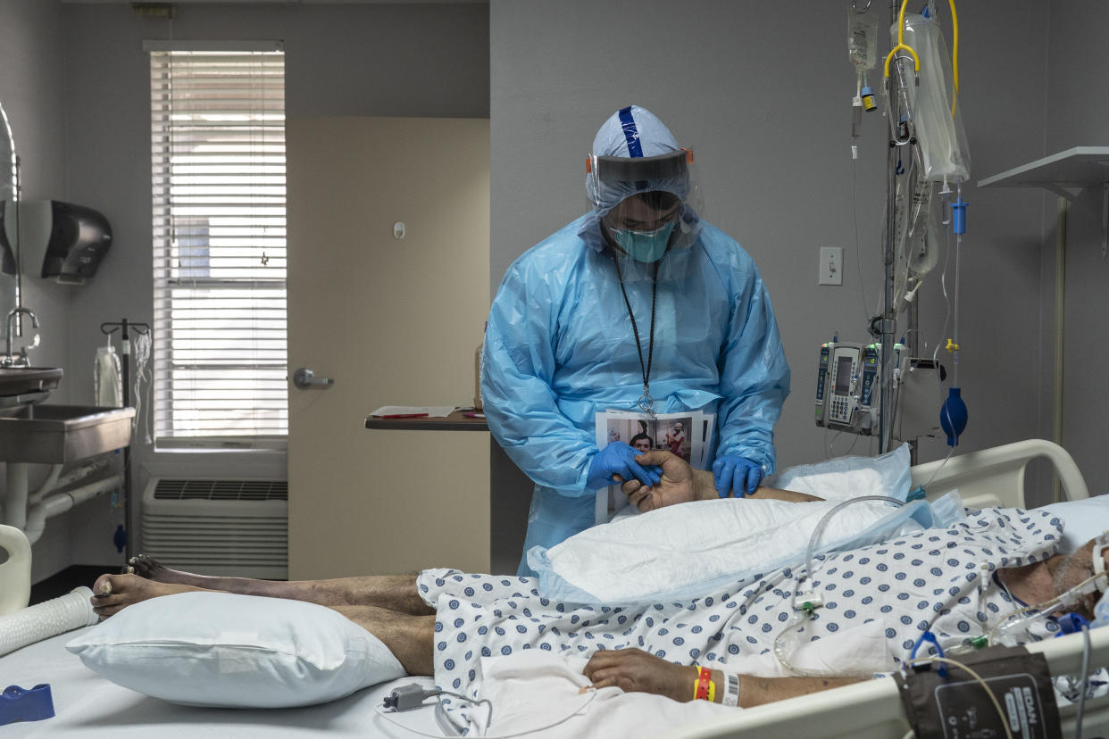 A medical staff member takes pulse of a patient in the COVID-19 intensive care unit (ICU) during Thanksgiving at the United Memorial Medical Center on November 26, 2020 in Houston, Texas. (Go Nakamura/Getty Images)