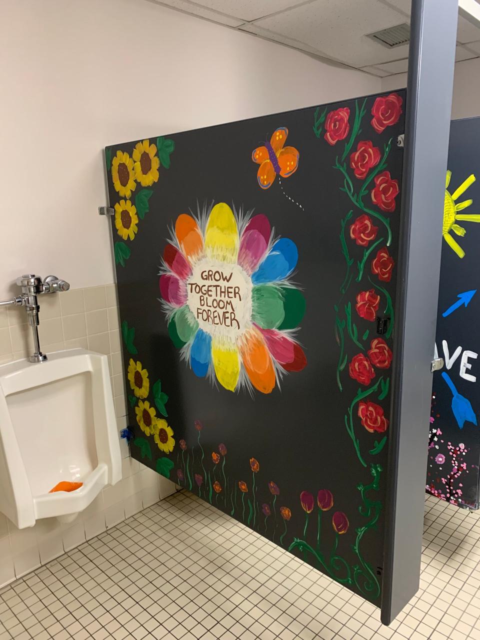 At Odyssey Charter, parents and teachers painted murals on bathroom stalls to welcome students back to school.