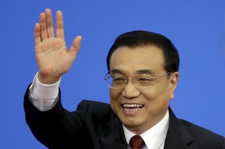 Premier Li Keqiang waves as he leaves after a news conference following the closing ceremony of National People's Congress (NPC) at the Great Hall of the People in Beijing, China, March 16, 2016. REUTERS/Jason Lee