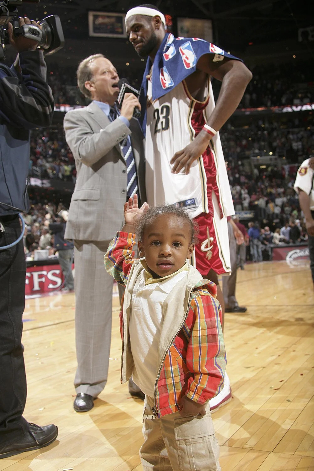 LeBron James #23 of the Cleveland Cavaliers with his son speaks to the media after playing against the Detroit Pistons in game three of the Eastern Conference Semifinals during the 2006 NBA Playoffs at the Quicken Loans Arena on May 13, 2006 in Cleveland,Ohio.