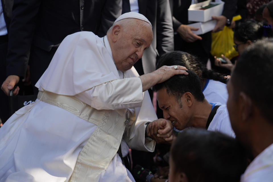 Pope Francis consoles a person during a visit at the 'Irmas ALMA' (Sisters of the Association of Lay Missionaries) School for Children with Disabilities in Dili, East Timor, Tuesday, Sept. 10, 2024. Pope Francis has indirectly acknowledged the abuse scandal in East Timor involving its Nobel Peace Prize-winning independence hero Bishop Carlos Filipe Ximenes Belo. (AP Photo/Gregorio Borgia)