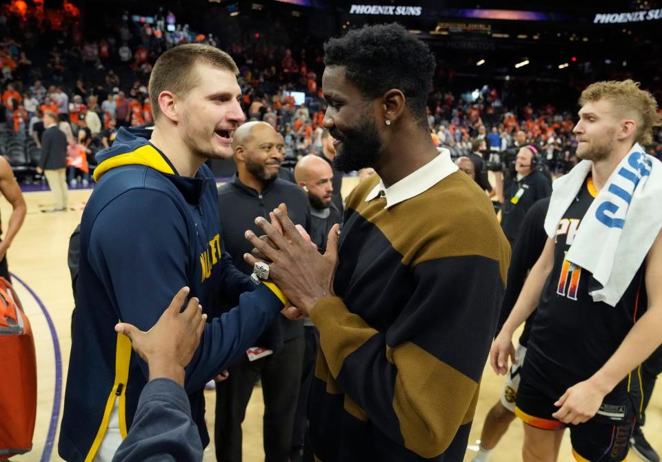 Denver Nuggets center Nikola Jokic (15) shakes hands with Phoenix Suns center Deandre Ayton (22) after winning Game 6 of the Western Conference semifinals, eliminating the Suns, at Footprint Center in Phoenix on May 11, 2023.