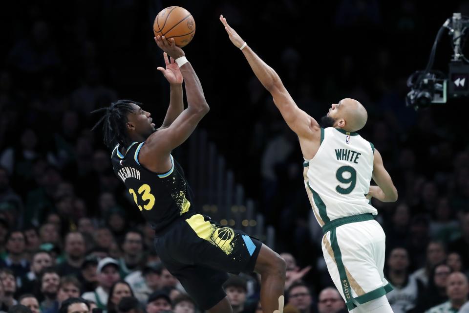 Indiana Pacers' Aaron Nesmith (23) shoots against Boston Celtics' Derrick White (9) during the first half of an NBA basketball game, Tuesday, Jan. 30, 2024, in Boston. (AP Photo/Michael Dwyer)