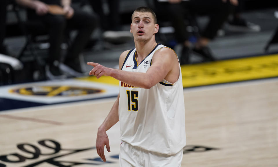 Denver Nuggets center Nikola Jokic directs his teammates against the Utah Jazz in the second half of an NBA basketball game Sunday, Jan. 31, 2021, in Denver. (AP Photo/David Zalubowski)