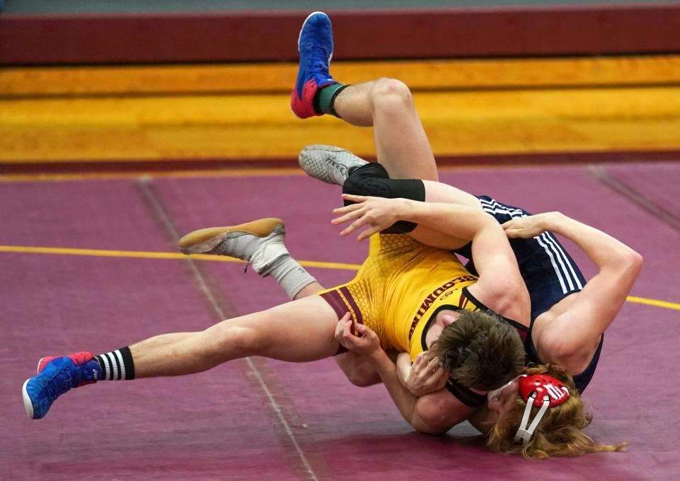 Bloomington North's Cael Hickok (in gold) wrestles BNL's Reese Hamblen in the 145-pound match at North during the 2021 season.