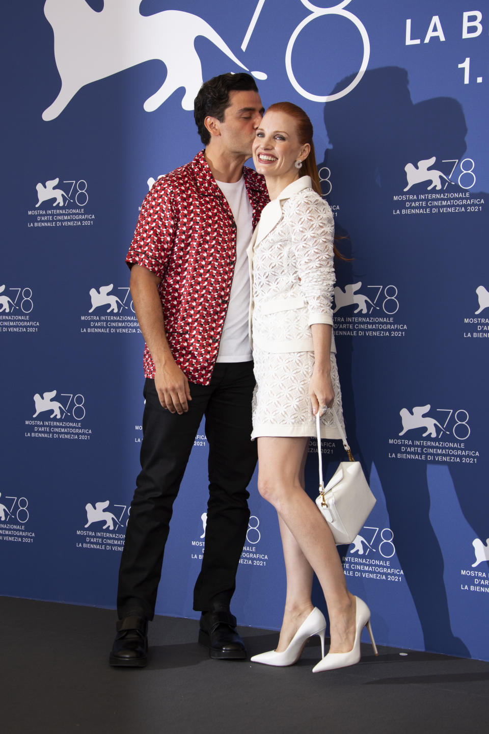 Oscar Isaac, left, and Jessica Chastain pose for photographers at the photo call for the film 'Scenes of a Marriage' during the 78th edition of the Venice Film Festival in Venice, Italy, Saturday, Sep, 4, 2021. (Photo by Joel C Ryan/Invision/AP)