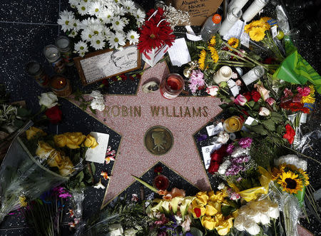 Flowers are seen on the late Robin Williams' star on the Hollywood Walk of Fame in Los Angeles, California August 12, 2014. REUTERS/Lucy Nicholson
