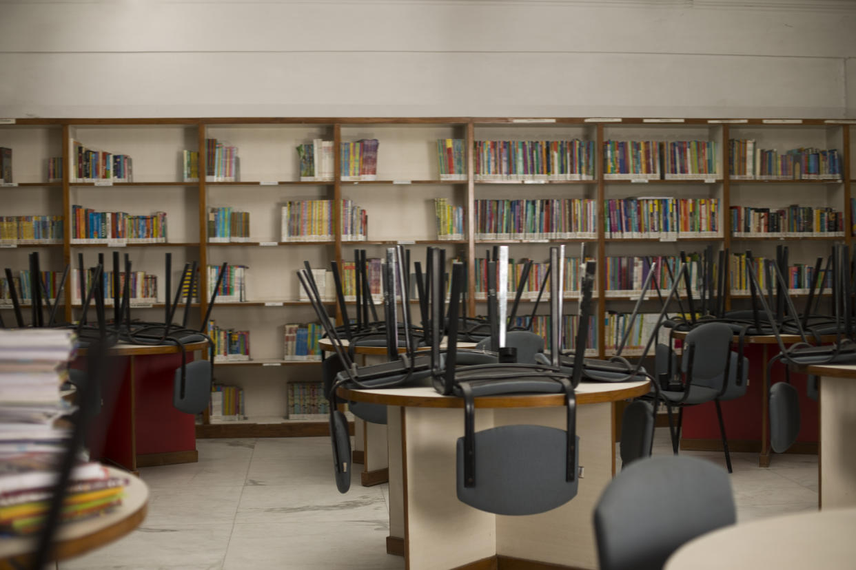 Chairs upside down on tables in public library