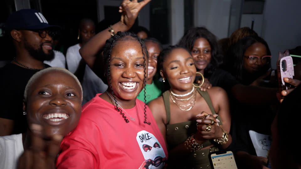 Simi (center-right, wearing olive green) greets her fans in Lagos, Nigeria. - CNN