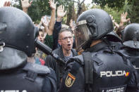 <p>People are facing the Spanish police ‘Policia Nacional’ after they closed down a polling station. Today the referendum was held to vote for the independence of Catalunya region. (Photo: Andrea Baldo/LightRocket via Getty Images) </p>