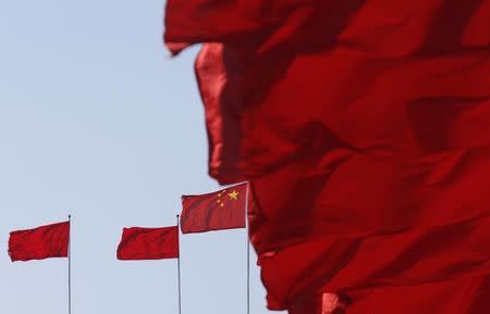 Flags flutter ahead of the opening session of Chinese People's Political Consultative Conference (CPPCC) at Tiananmen Square in Beijing, March 3, 2015. REUTERS/Kim Kyung-Hoon