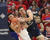 Dayton's Ibi Watson (2) battles George Washington's Javier Langarica (32) for a rebound during the second half of an NCAA college basketball game Saturday, March 7, 2020, in Dayton, Ohio. (AP Photo/Tony Tribble)