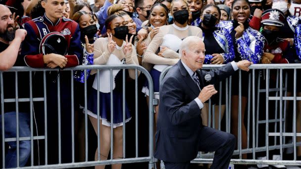 PHOTO: President Joe Biden kneels to pose for a picture as he participates in a Democratic National Committee rally at Richard Montgomery High School in Rockville, Md., Aug. 25, 2022. (Jonathan Ernst/Reuters)