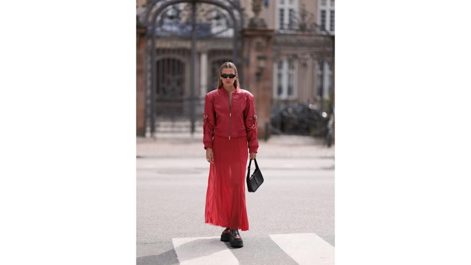 Alessa Winter wearing top to toe red in varying textures plus a Saint Laurent bag. 