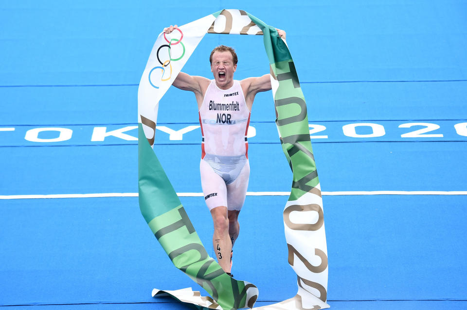 <p>Norway's Kristian Blummenfelt triumphantly holds up the Olympics banner following his men's individual triathlon competition win at the Odaiba Marine Park on July 26.</p>