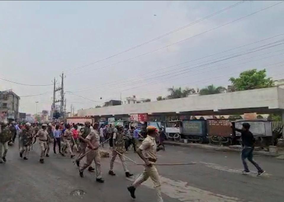 Police try to control a crowd shouting slogans during a protest soon after the beheading (AP)