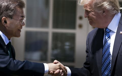 This file photo taken on June 30, 2017 shows South Korea's President Moon Jae-in and US President Donald Trump shaking hands in the Rose Garden of the White House in Washington - Credit: AFP