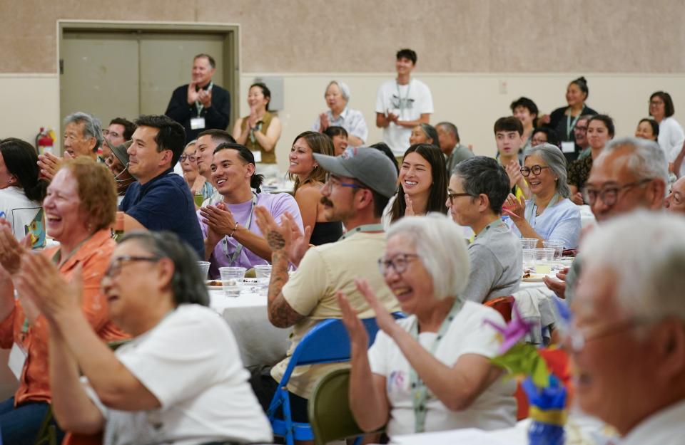 Attendees clap during a closing dinner program at the Twin Falls County Fairgrounds, Saturday, July 8, 2023, in Filer, Idaho. (AP Photo/Lindsey Wasson)
