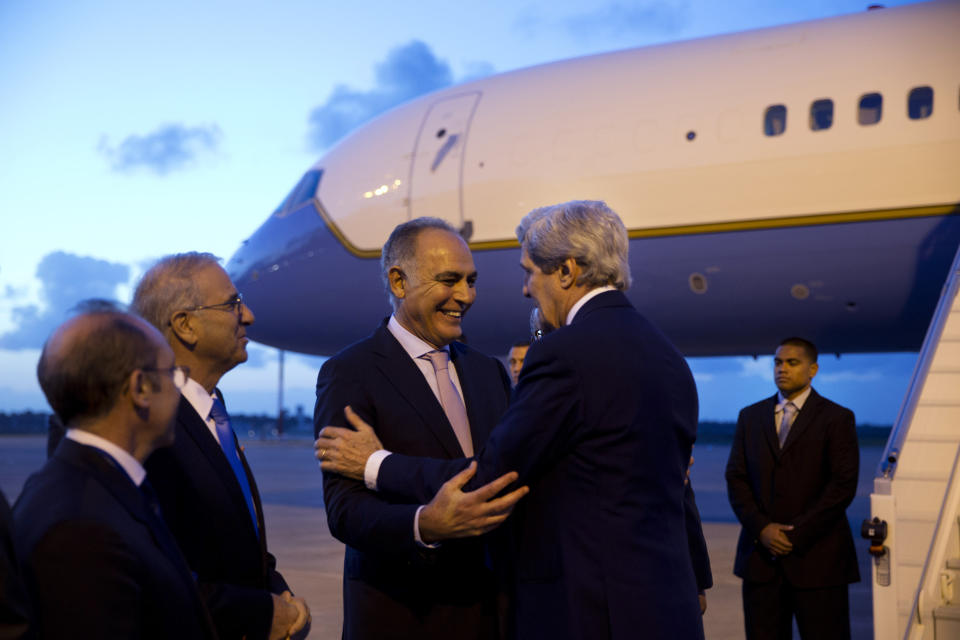 In this April 3, 2014, photo, U.S. Secretary of State John Kerry, right, is greeted by Moroccan Foreign Minister Salaheddine Mezouar on the secretary's arrival in Rabat, Morocco. The current trip was to have been a five-day trip to Europe and Saudi Arabia, but with crisis on multiple fronts and Kerry’s decision on how to proceed turned a routine trip abroad into a frenetic tour of high-stakes diplomacy marked by abrupt changes in plan that have come to define his 14-month tenure as secretary of state. (AP Photo/Jacquelyn Martin, Pool)